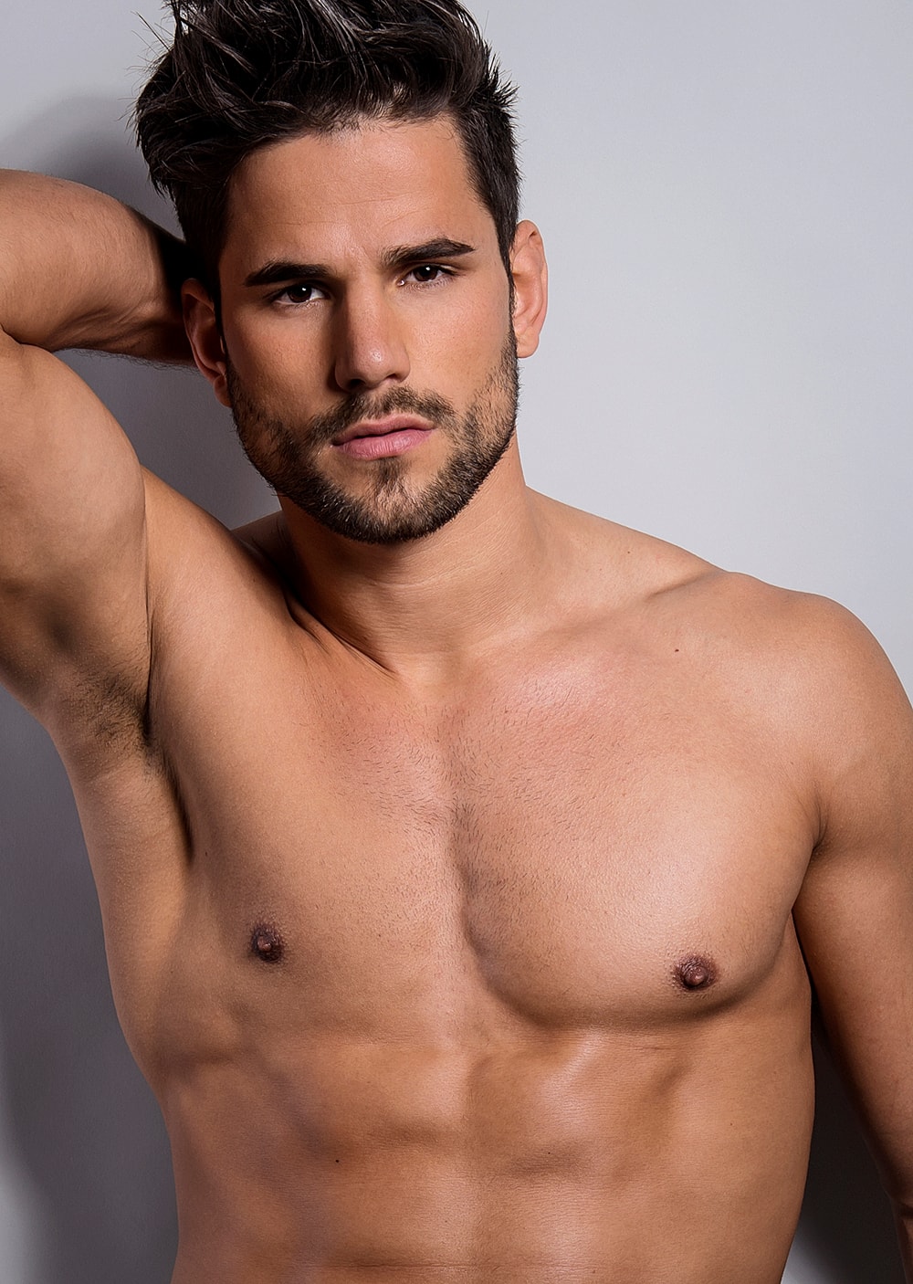 Portrait of a muscular man with short hair.